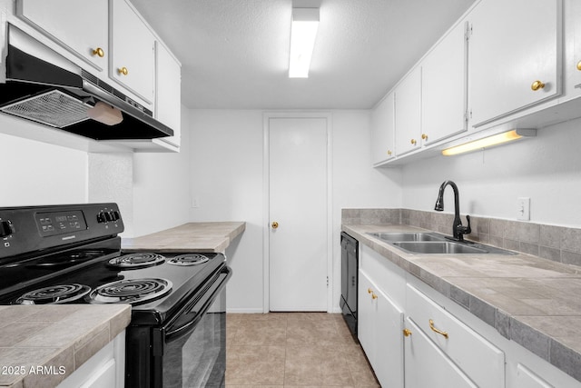 kitchen featuring sink, tile countertops, black appliances, and white cabinets