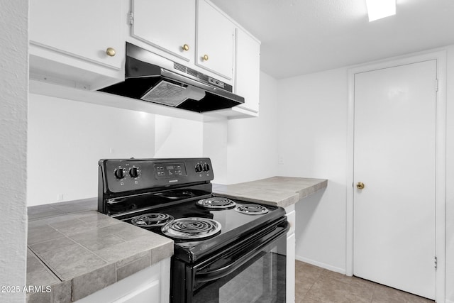 kitchen with white cabinetry, black electric range oven, and light tile patterned floors