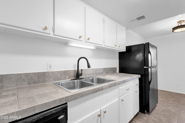 kitchen with white cabinetry, light tile patterned floors, sink, and black appliances