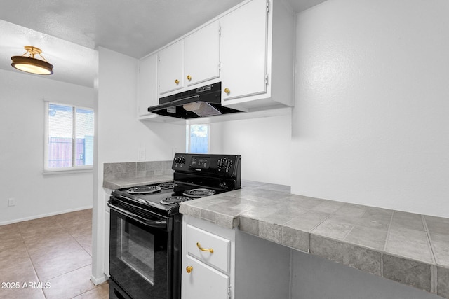 kitchen with black range with electric stovetop, light tile patterned floors, tile countertops, and white cabinets