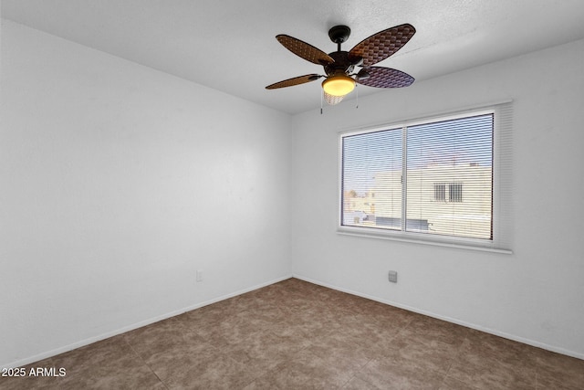 spare room with ceiling fan