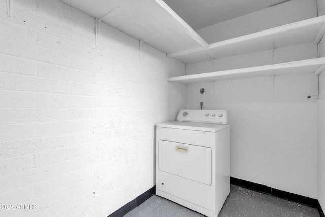 clothes washing area with washer / dryer