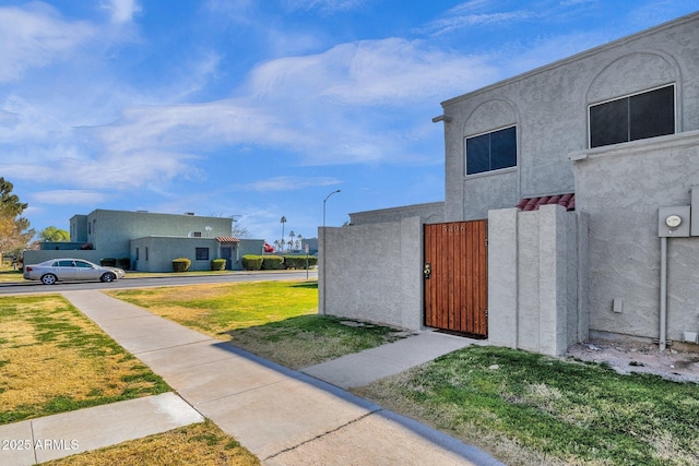 view of property exterior featuring a lawn