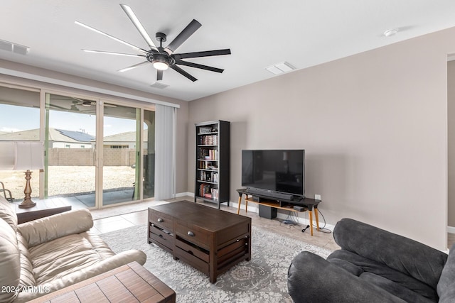 tiled living room with ceiling fan