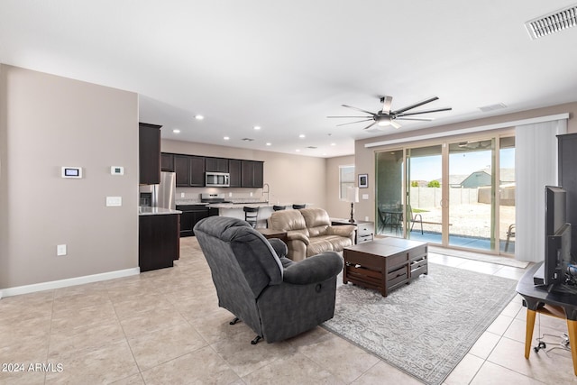 living room featuring ceiling fan and light tile patterned floors