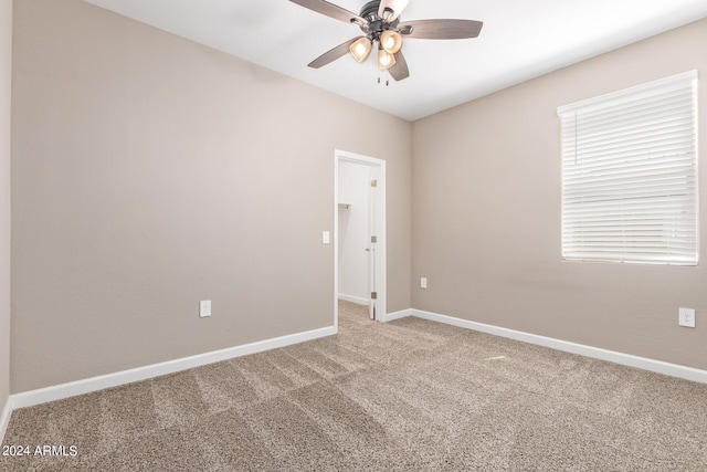 carpeted empty room with ceiling fan