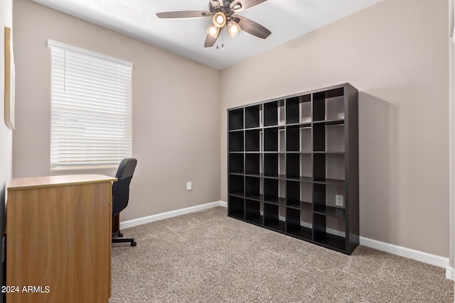 unfurnished office with ceiling fan and light colored carpet