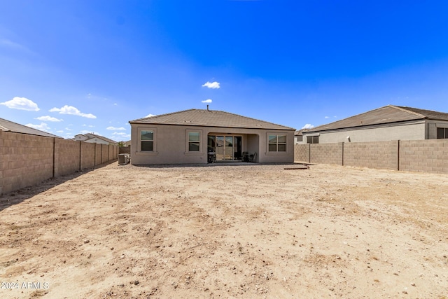 rear view of property with central AC