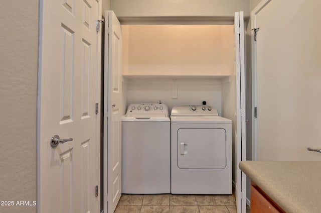 14870 W Encanto Blvd Unit 1038, Goodyear, AZ 85395 - laundry room with washer and clothes dryer, a textured wall, and light tile patterned floors