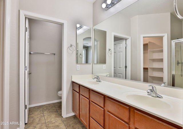 14870 W Encanto Blvd Unit 1038, Goodyear, AZ 85395 - full bath with double vanity, a shower with shower door, tile patterned floors, and a closet