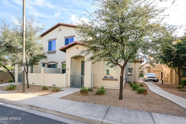 14870 W Encanto Blvd Unit 1038, Goodyear, AZ 85395 - mediterranean / spanish home with stucco siding, a tiled roof, and a gate