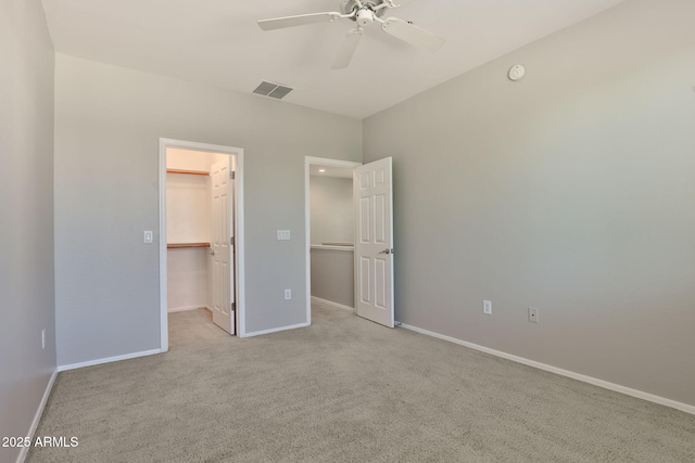 14870 W Encanto Blvd Unit 1038, Goodyear, AZ 85395 - unfurnished bedroom featuring a spacious closet, carpet flooring, a closet, and a ceiling fan