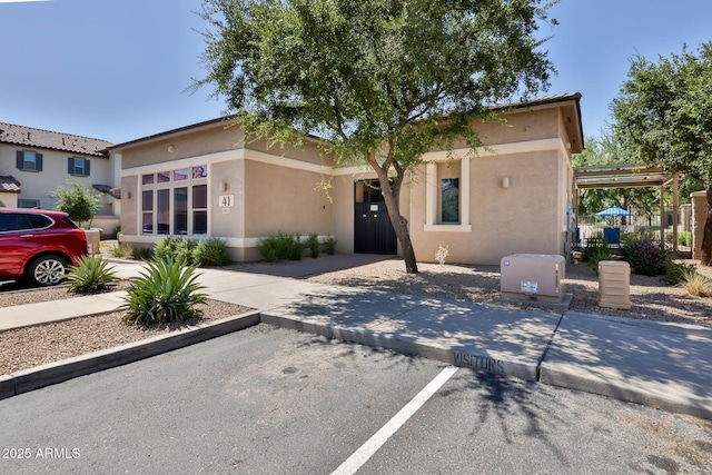14870 W Encanto Blvd Unit 1038, Goodyear, AZ 85395 - view of front of home featuring uncovered parking and stucco siding