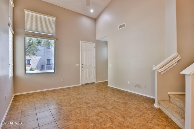 14870 W Encanto Blvd Unit 1038, Goodyear, AZ 85395 - spare room with high vaulted ceiling, a ceiling fan, and stairs