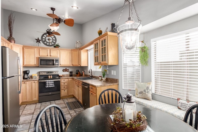 1214 W Sand Dune Dr, Gilbert, AZ 85233 - kitchen featuring appliances with stainless steel finishes, a sink, light brown cabinetry, ceiling fan, and a high ceiling