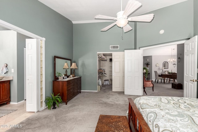1214 W Sand Dune Dr, Gilbert, AZ 85233 - bedroom featuring a towering ceiling, light colored carpet, a chandelier, baseboards, and a walk in closet