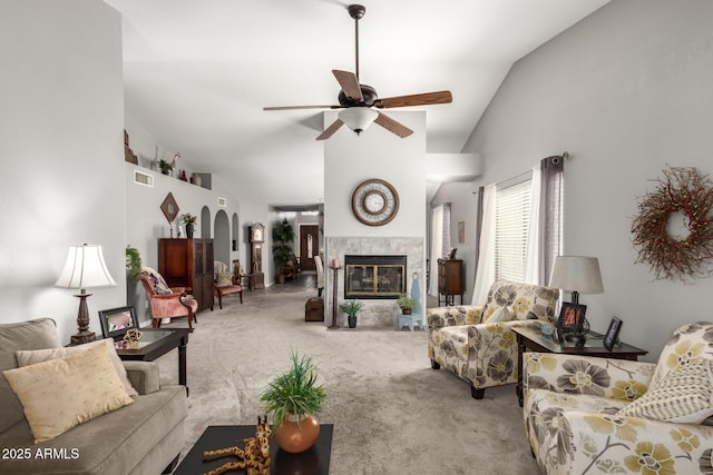1214 W Sand Dune Dr, Gilbert, AZ 85233 - living area with carpet floors, ceiling fan, a tiled fireplace, arched walkways, and high vaulted ceiling
