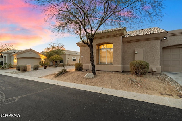 4744 E Casey Ln, Cave Creek, AZ 85331 - mediterranean / spanish home featuring a garage, concrete driveway, a tiled roof, and stucco siding