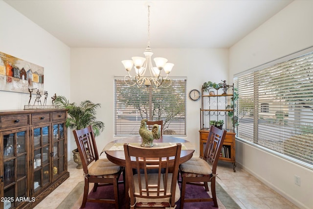 dining room with a notable chandelier, baseboards, and light tile patterned floors