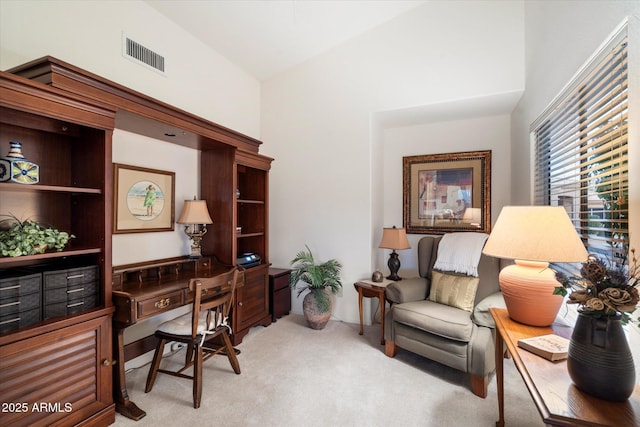 office space with light carpet, high vaulted ceiling, and visible vents