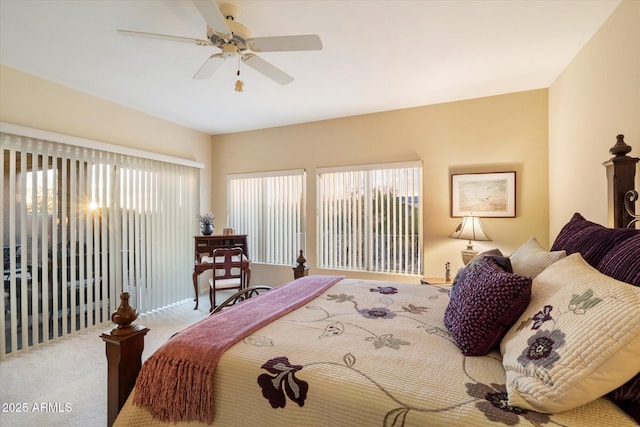 carpeted bedroom featuring a ceiling fan and multiple windows