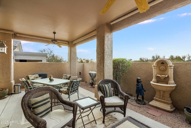 view of patio / terrace with a fenced backyard, a ceiling fan, and outdoor dining space