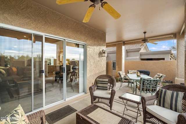 view of patio featuring outdoor dining space, fence, and a ceiling fan