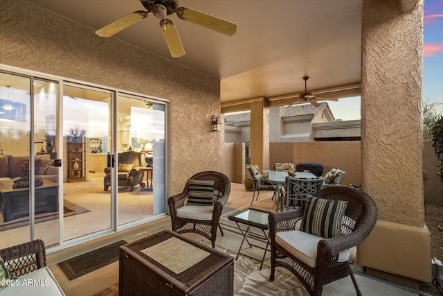 view of patio / terrace featuring fence, outdoor dining area, and a ceiling fan