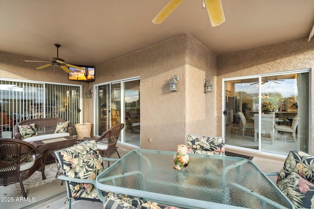 view of patio featuring outdoor dining space and a ceiling fan