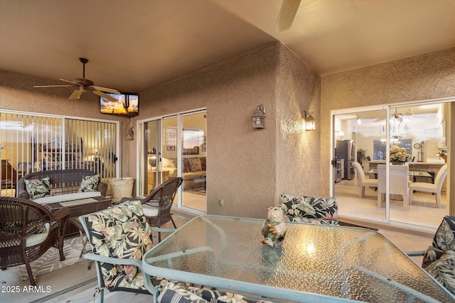 view of patio with a ceiling fan and outdoor dining area