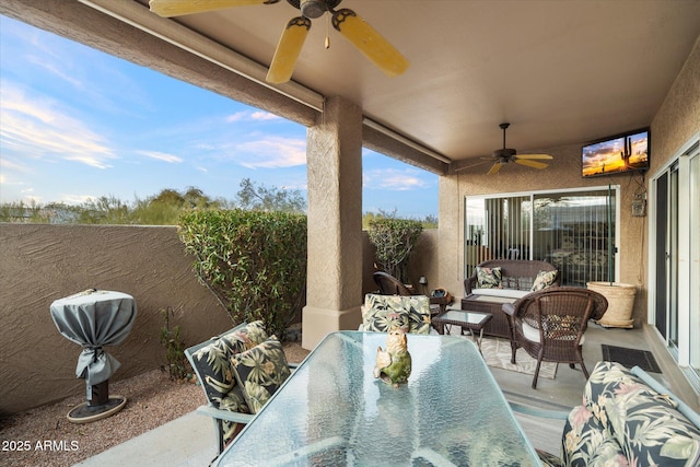 view of patio featuring outdoor dining space, an outdoor living space, a fenced backyard, and a ceiling fan