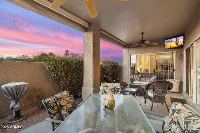 view of patio featuring a fenced backyard, an outdoor living space, a ceiling fan, and outdoor dining space