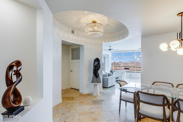 hallway featuring a notable chandelier