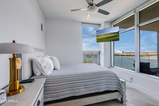 bedroom with hardwood / wood-style flooring and ceiling fan