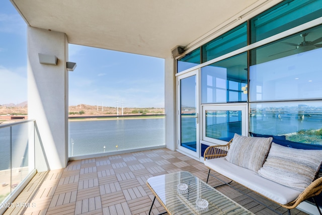 balcony featuring outdoor lounge area and a water view