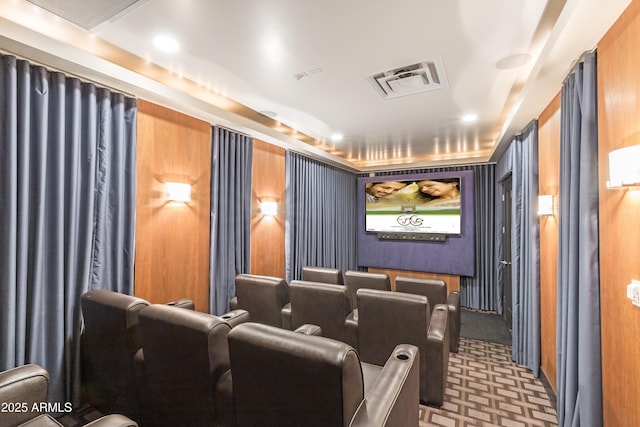 carpeted cinema room featuring wood walls