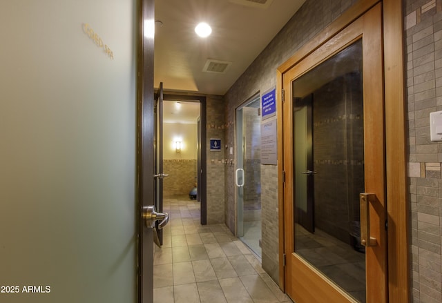 bathroom featuring tile patterned floors and tile walls