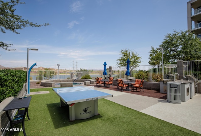 exterior space with a lawn, a patio area, and a pool