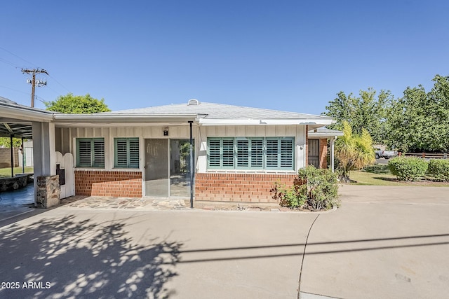 1945 E Solano Dr, Phoenix, AZ 85016 - ranch-style house featuring brick siding, board and batten siding, and a patio