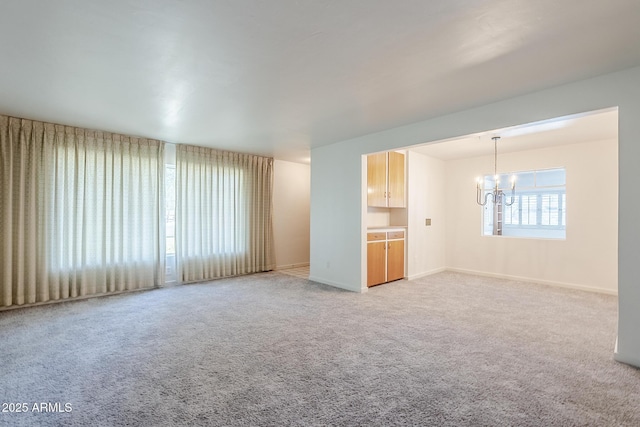 1945 E Solano Dr, Phoenix, AZ 85016 - unfurnished living room with a chandelier and light carpet