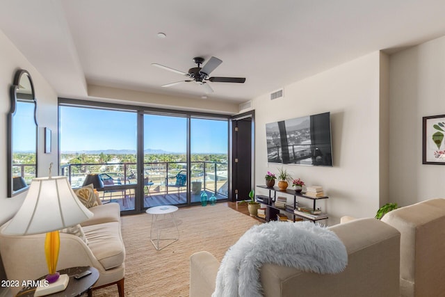 living room with ceiling fan and plenty of natural light