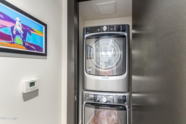 laundry area featuring stacked washer / dryer