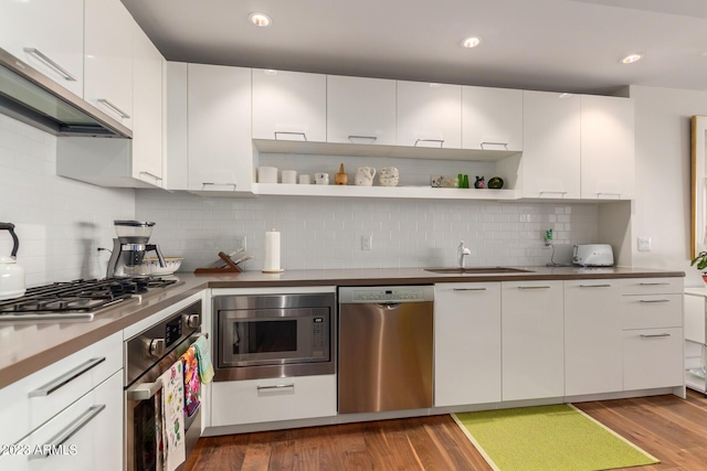 kitchen with sink, white cabinetry, decorative backsplash, and appliances with stainless steel finishes