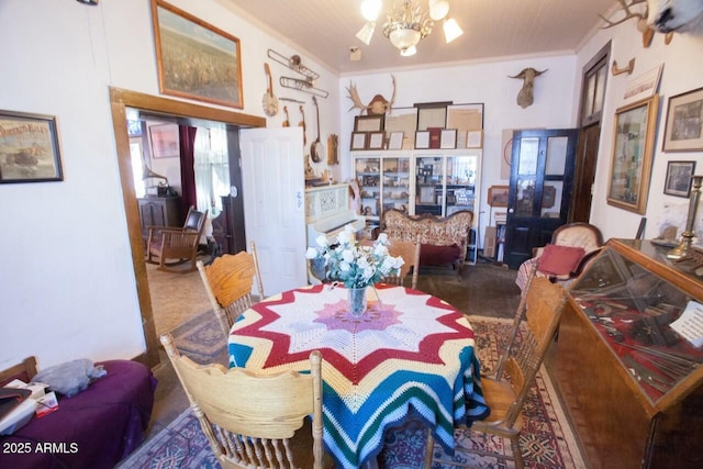 dining space featuring a notable chandelier and crown molding