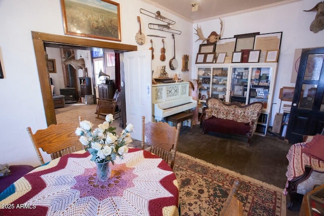 carpeted dining room featuring crown molding