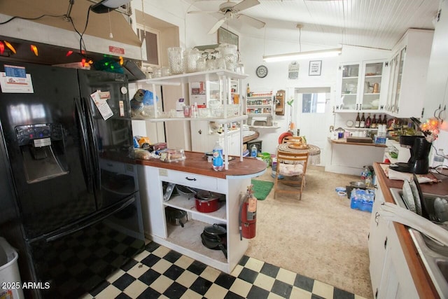 kitchen with black fridge with ice dispenser, white cabinets, lofted ceiling, and ceiling fan