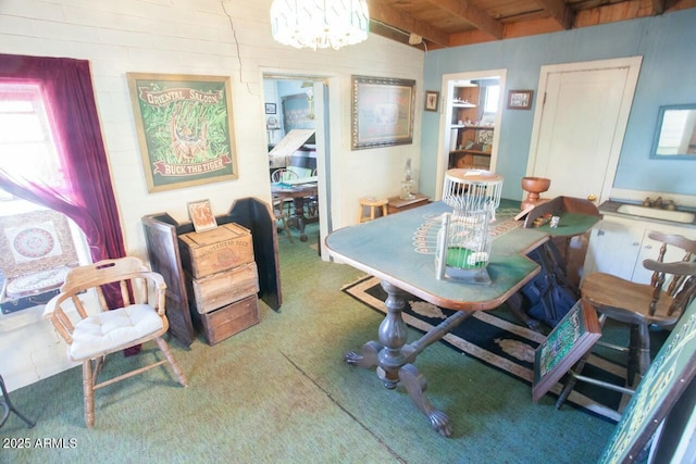 carpeted dining room with wood ceiling, a chandelier, and beamed ceiling