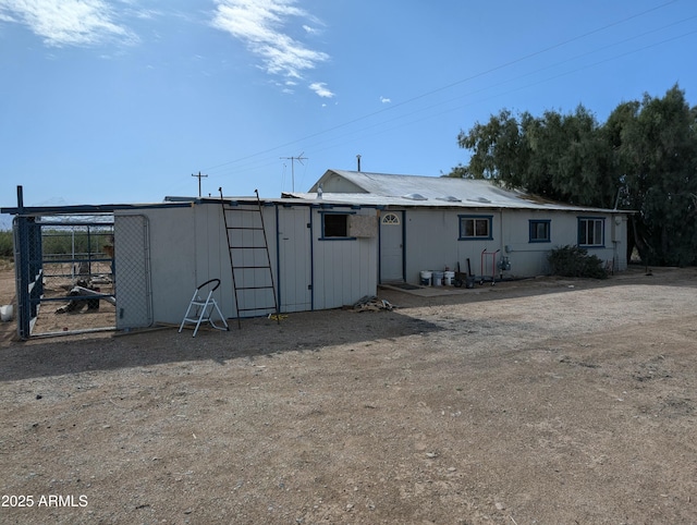 back of property with an outdoor structure