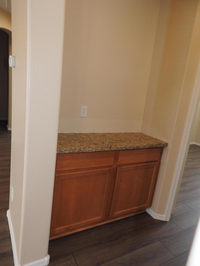 room details with baseboards and wood finished floors