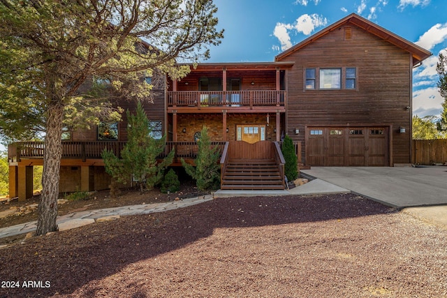 view of front of property with a balcony and a garage